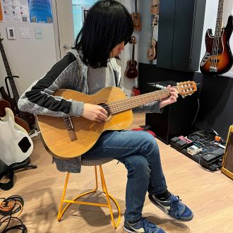 Playing guitar in the studio