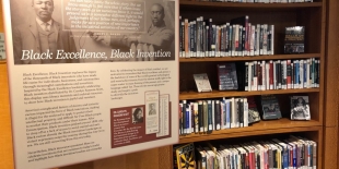 AAC room with books and Black Excellence exhibit panel 