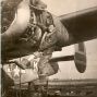 In the center of the image is a sepia photograph of a grinning army sergeant posing near a propeller plane. On the left is the logo of the APIA Biography Project. On the right is the logo of the Square and Circle Club.