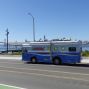 Bookmobile on a street in Treasure Island with the Bay Bridge, bay and City in the background.
